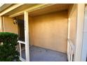 Small covered porch with white railings and a light fixture at 11822 Raintree Dr, Temple Terrace, FL 33617