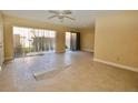 Living room with tile floors and sliding doors leading to a patio at 11822 Raintree Dr, Temple Terrace, FL 33617