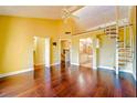 Bright living room with hardwood floors and spiral staircase leading to a loft or upper level at 1710 Lighthouse S Ter # 1, South Pasadena, FL 33707