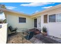 Small patio with table and chairs, adjacent to the house entrance at 1711 Patlin S Cir, Largo, FL 33770