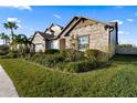 Stone house with lush landscaping and palm trees at 18017 Pine Hammock Blvd, Lutz, FL 33548