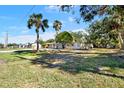 Side view of a single-story house with mature trees at 4205 N Manhattan Ave, Tampa, FL 33614