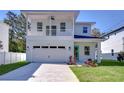 Two-story house with balcony, attached garage, and landscaped lawn at 515 Elm St, Safety Harbor, FL 34695
