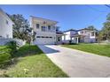 Two-story house with balcony, attached garage, and landscaped lawn at 515 Elm St, Safety Harbor, FL 34695