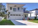 Two-story house with balcony, attached garage, and landscaped lawn at 515 Elm St, Safety Harbor, FL 34695