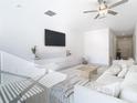 Living room with sectional sofa, large TV, and light wood coffee table at 8849 Little Bluestem Dr, Land O Lakes, FL 34637