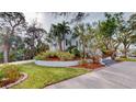 A light-blue two-story house with a nicely landscaped yard and a long driveway at 9034 Baywood Park Dr, Seminole, FL 33777