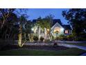 Two-story house with a well-manicured lawn and palm trees in the front yard at 9034 Baywood Park Dr, Seminole, FL 33777