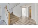 Modern staircase with wooden railing and carpeted steps at 11217 Avery Oaks Dr, Tampa, FL 33625