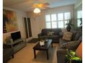 Living room with grey sofas, a coffee table, and a view of the entrance at 6000 20Th N St # 114, St Petersburg, FL 33714