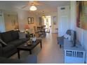Bright living room with comfy sofas, a coffee table, and a dining area at 6000 20Th N St # 114, St Petersburg, FL 33714