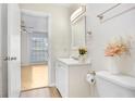 Cozy bathroom with white vanity and cabinets, with access to a bedroom visible in the background at 8609 Mallard Reserve Dr # 202, Tampa, FL 33614