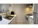 Full view of updated kitchen with white appliances and cabinetry at 1799 N Highland Ave # 152, Clearwater, FL 33755