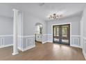 Light and airy dining room with hardwood floors and access to the kitchen at 4290 Yucatan Cir, Port Charlotte, FL 33948