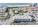 Aerial view of condo building showcasing its layout and proximity to the beach at 6767 Sunset Way # 301, St Pete Beach, FL 33706