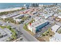 Aerial view showing condo building's location near beach and other buildings at 6767 Sunset Way # 301, St Pete Beach, FL 33706