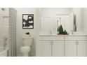 Bathroom with double vanity, white cabinets, and a shower/tub combo at 7020 E 119Th Ct, Palmetto, FL 34221