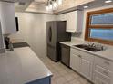 Kitchen with stainless steel appliances and white cabinets at 9744 Lake Seminole E Dr, Largo, FL 33773