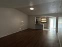 Living room with dark hardwood floors and view into kitchen at 9744 Lake Seminole E Dr, Largo, FL 33773