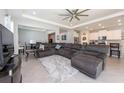 Spacious living room featuring a sectional sofa and large TV at 12512 Brick Cobblestone Dr, Riverview, FL 33579