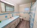 Clean bathroom with light blue vanity and updated flooring at 2331 Belleair Rd # 611, Clearwater, FL 33764