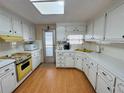 Bright kitchen featuring wood-look flooring and ample cabinetry at 2331 Belleair Rd # 611, Clearwater, FL 33764