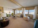 Spacious living room with neutral carpeting and comfortable seating at 2331 Belleair Rd # 611, Clearwater, FL 33764