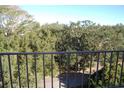 Balcony view overlooking tree-lined street and neighborhood at 2699 Seville Blvd # 605, Clearwater, FL 33764