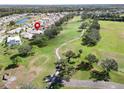 Property situated on a golf course community with a pond nearby at 334 Caloosa Palms Ct, Sun City Center, FL 33573