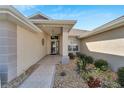 Front entrance with walkway, landscaping, and covered entry at 334 Caloosa Palms Ct, Sun City Center, FL 33573
