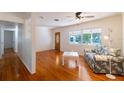 Bright living room with hardwood floors, large windows, ceiling fan, and a cozy sitting area with a modern couch at 3873 21St N Ave, St Petersburg, FL 33713