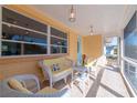 Charming covered patio with wicker furniture, tile flooring, and bright natural light, perfect for relaxing at 3873 21St N Ave, St Petersburg, FL 33713