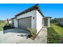 New construction home with gray garage door at 39822 Harmon Grove Ct, Zephyrhills, FL 33540