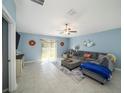 Spacious living room with sectional sofa and tile floors at 39822 Harmon Grove Ct, Zephyrhills, FL 33540