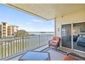 Relax on this condo balcony with comfortable seating and panoramic water views at 399 150Th Ave # A203, Madeira Beach, FL 33708