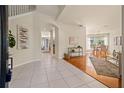 Bright and spacious entryway with tile flooring, hardwood accents, and views into the living and dining areas at 2215 Clarine N Way, Dunedin, FL 34698