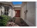 Brick walkway leading to a brown front door at 29417 Caddyshack Ln, San Antonio, FL 33576