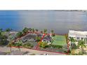Aerial view of two houses, tennis court, and waterfront access at 5029 W San Miguel St, Tampa, FL 33629