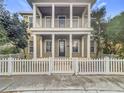 Two-story house with a front porch and white picket fence at 10130 Balcony St, New Port Richey, FL 34655