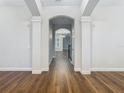 Bright hallway with hardwood floors and arched doorways at 10130 Balcony St, New Port Richey, FL 34655