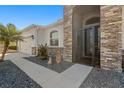 Inviting front entrance with a stone facade and screened door at 10431 Machrihanish Cir, San Antonio, FL 33576