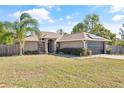 House exterior showcasing the front yard and solar panels at 11081 Montcalm Rd, Spring Hill, FL 34608