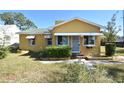 Yellow house with a green roof and a yard at 1360 Prescott S St, St Petersburg, FL 33712