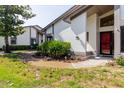 Inviting front entrance with a decorative red front door, manicured landscaping, and a well-maintained walkway at 1808 Cypress Trace Dr # 1808, Safety Harbor, FL 34695