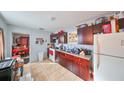 Bright kitchen with dark wood cabinets and granite countertops at 2045 18Th S Ave, St Petersburg, FL 33712