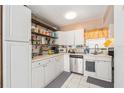 White kitchen with ample counter space and wooden shelving at 2625 State Road 590 # 2413, Clearwater, FL 33759