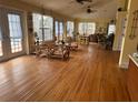 Bright and airy living room with hardwood floors and access to the pool at 4722 Trade Winds S Dr, Gulfport, FL 33711