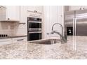 Modern kitchen with granite countertops and stainless steel appliances at 7465 Yale Harbor Dr, Wesley Chapel, FL 33545