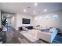Spacious living room featuring a large sectional sofa and hardwood floors at 7465 Yale Harbor Dr, Wesley Chapel, FL 33545