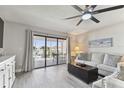 Bright living room with balcony access, comfy seating and ocean views at 1000 Gulf Blvd # 302, Indian Rocks Beach, FL 33785